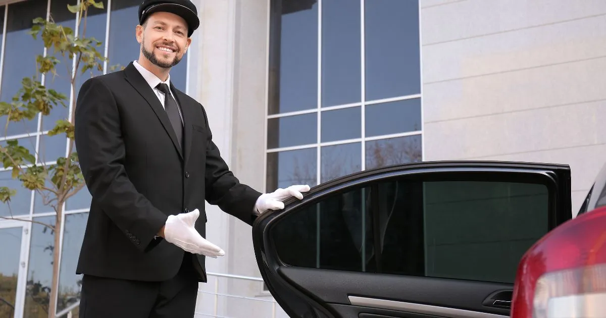 A Valet Attendant Says Good Bye To A Departing Guest