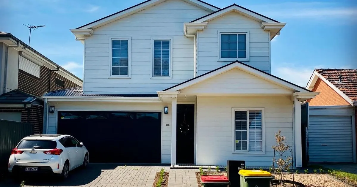 A White Car Parked In A Residential Parking Space On Rent