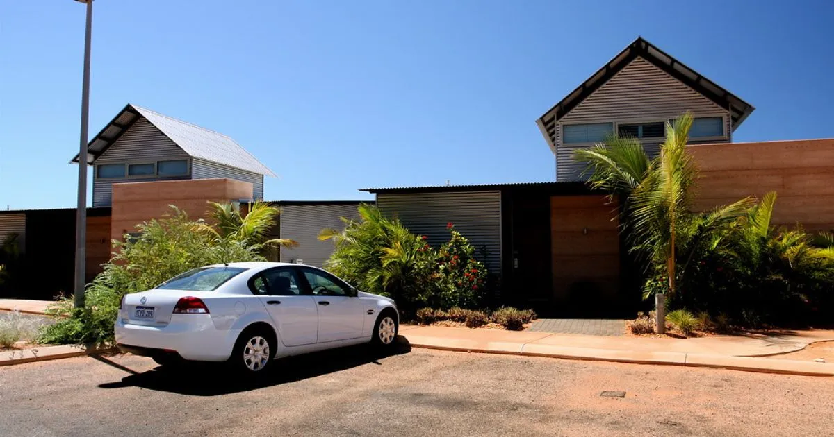A White Car Parked Outside A Beautiful House In Australia With Space Left For More Cars A White Car Parked Outside A Beautiful House In Australia With Space Left For More Cars