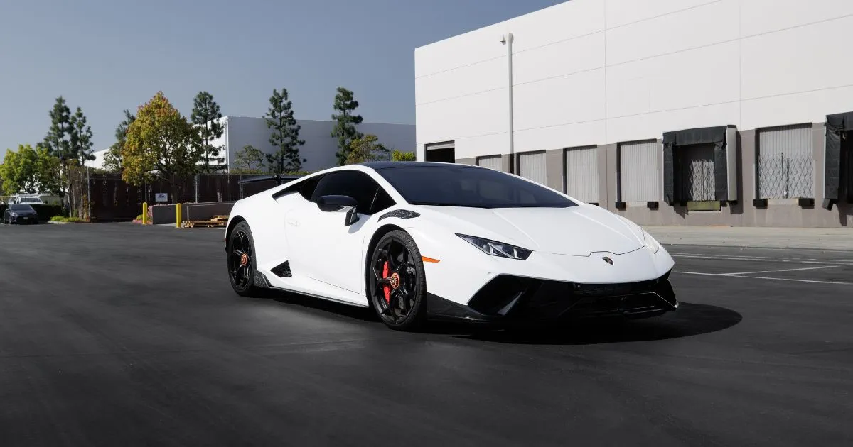 A White Lambo Parked In A Rental Parking Space