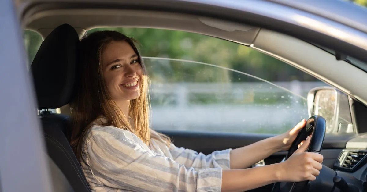 A Woman Giving A Smile After Parking Her Car Perfectly A Woman Giving A Smile After Parking Her Car Perfectly