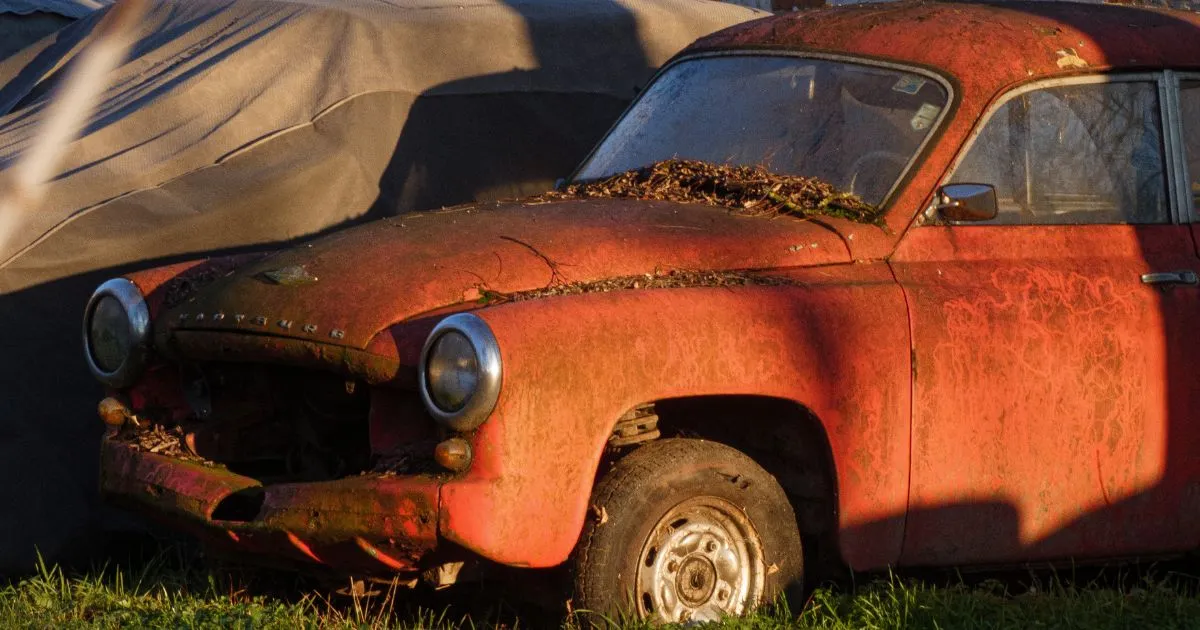 An Abandoned Old Model Car Rusting In A Garage An Abandoned Old Model Car Rusting In A Garage