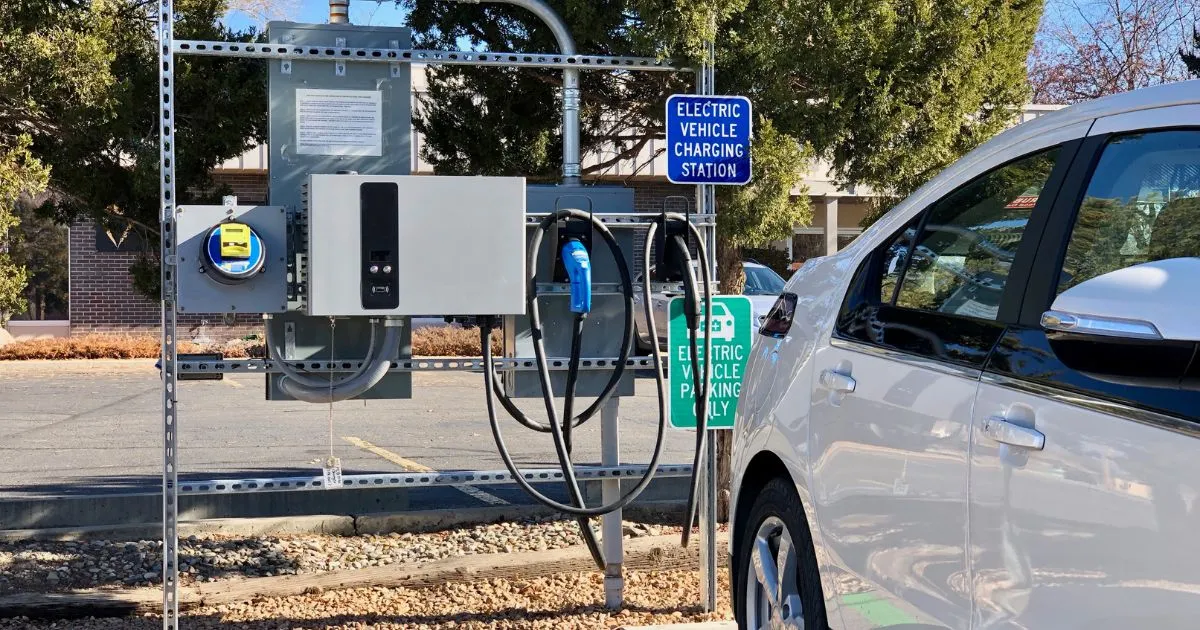 An Electric Vehicle Charging Station In A Parking Lot An Electric Vehicle Charging Station In A Parking Lot