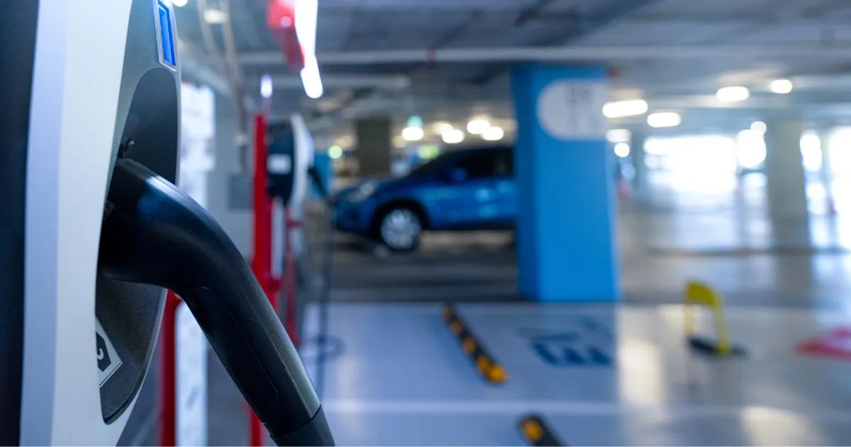 An Electric Vehicle Charging Station Installed In A Car Park