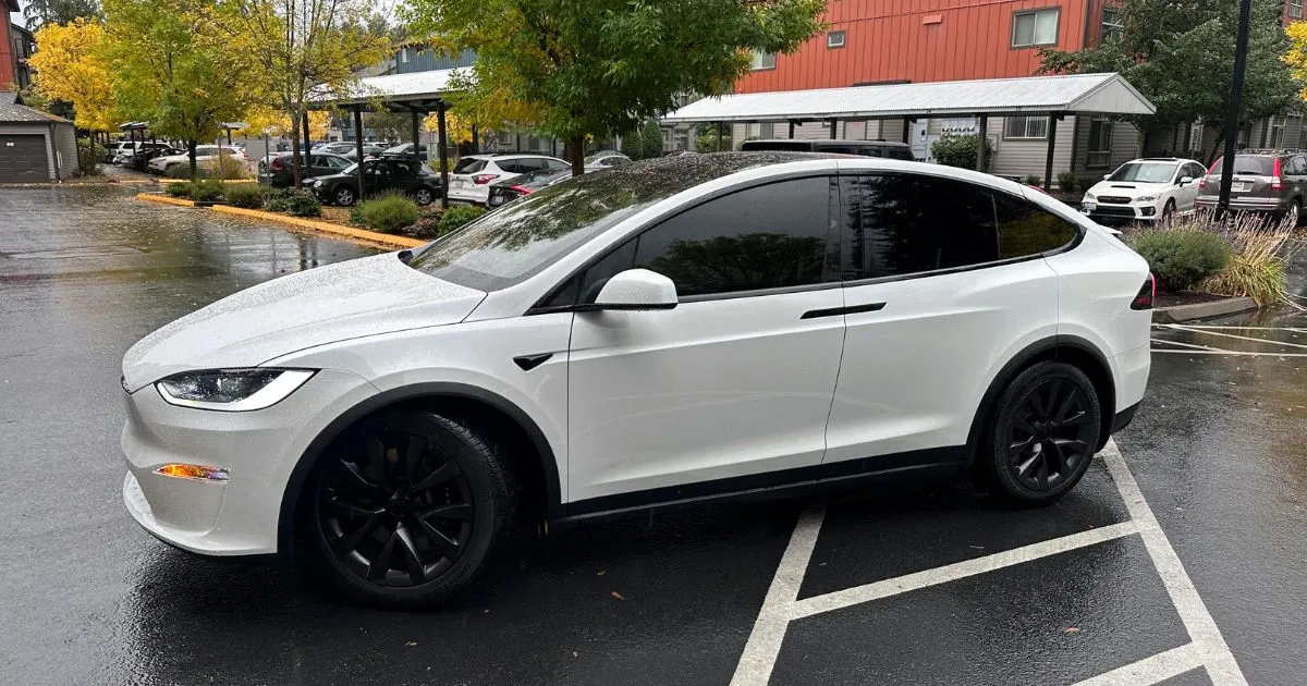 An Electric Vehicle In A Parking Space After Heavy Rain