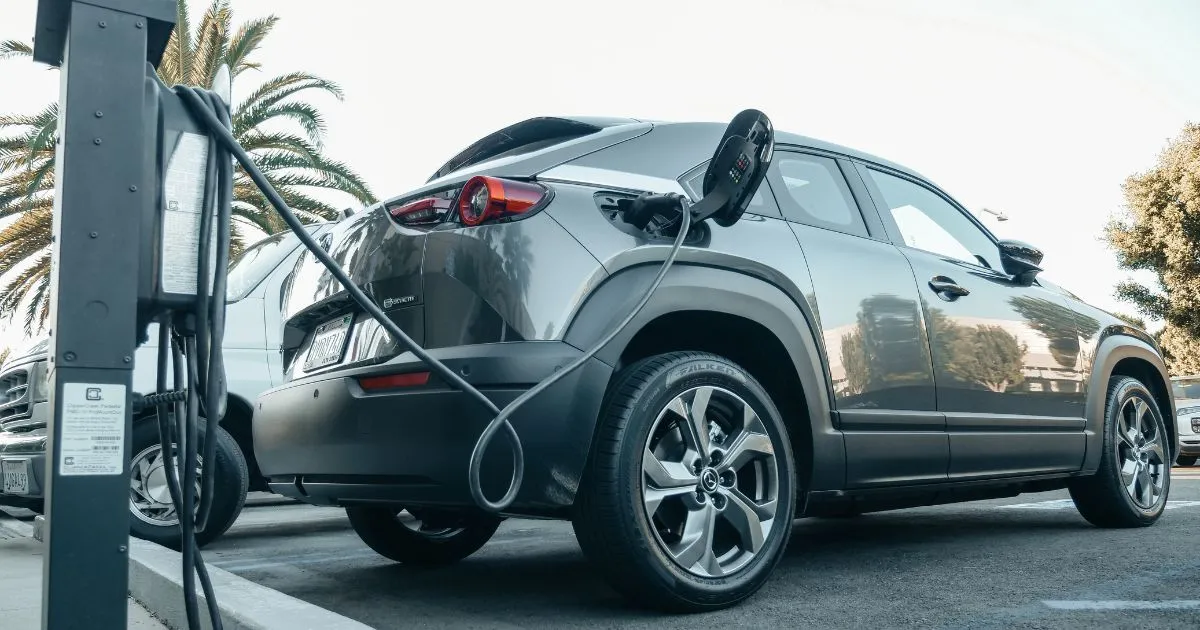 An Electric Vehicle On Charging In An Eco-Friendly Car Park An Electric Vehicle On Charging In An Eco-Friendly Car Park