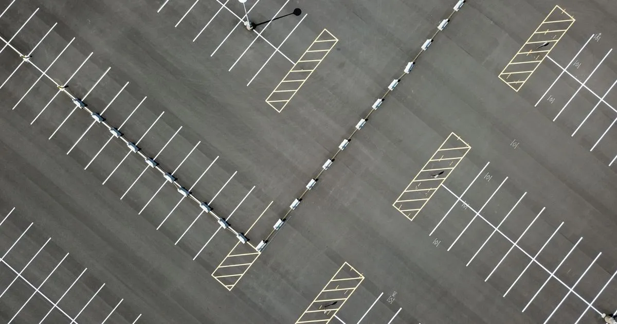 An Empty Parking Lot Ready To Host Numerous Vehicles An Empty Parking Lot Ready To Host Numerous Vehicles