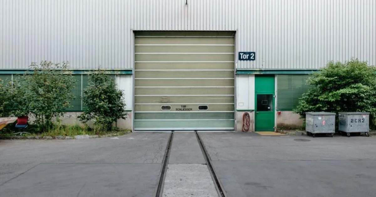 An Unused Parking Lot With A Huge Garage Door