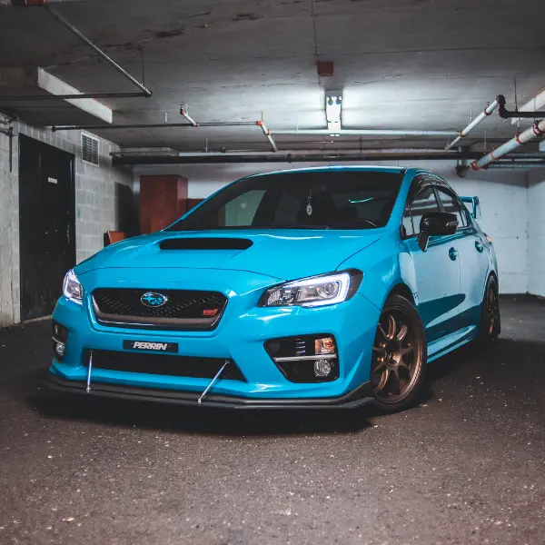 Blue performance car parked in a spot representing affordable parking near me options available in underground levels.