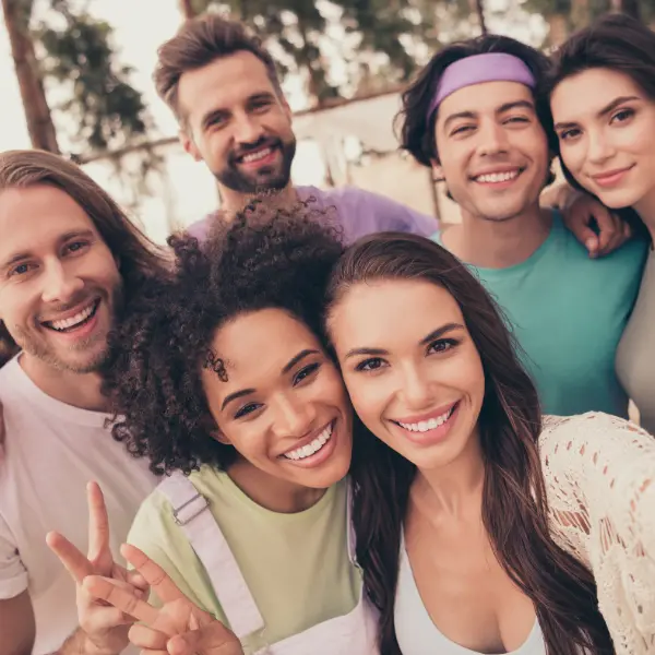 Friends Celebrating Parking Rewards Referral Savings Friends taking a selfie to celebrate the parking rewards referral that saves them money on city trips.