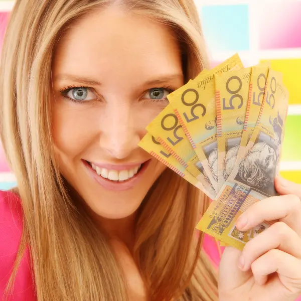 Woman holding fifty dollar notes showing the financial freedom you get when you rent driveway parking to local drivers.