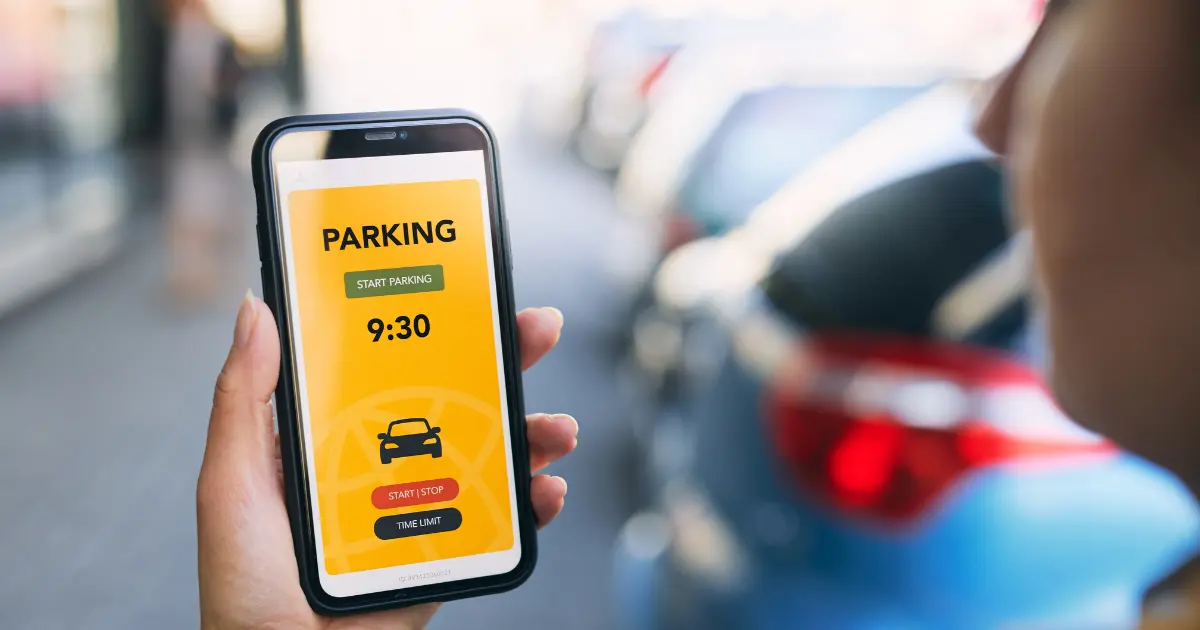 Lady Using Mobile To Book Parking Via An App Lady Using Mobile To Book Parking Via An App