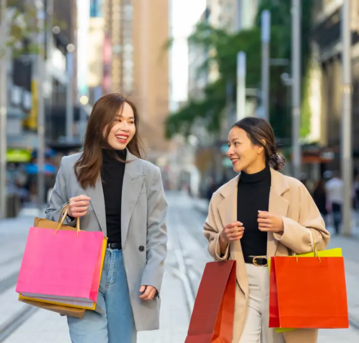 Shoppers Using Parking Referral Bonus For Big Savings Shoppers walking in the city using the parking referral bonus to save on secure spots near the malls.