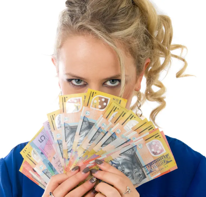 Woman holding fanned Australian banknotes showing how to make money renting parking space with our easy platform.