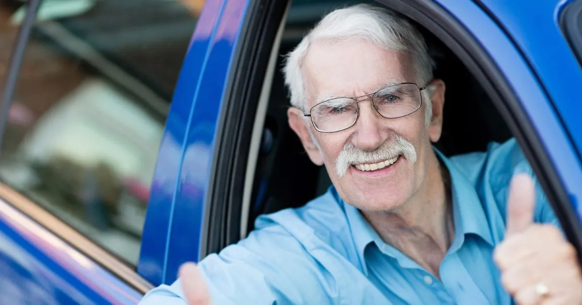 Older Gentleman Driver Giving Thumps Up In Car