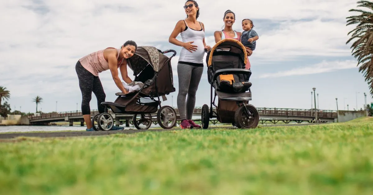 Parents With Prams In An Open Parking Space