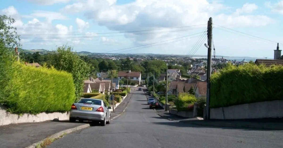 Some Downhill Parked Cars On The Main Road A Renowned Park