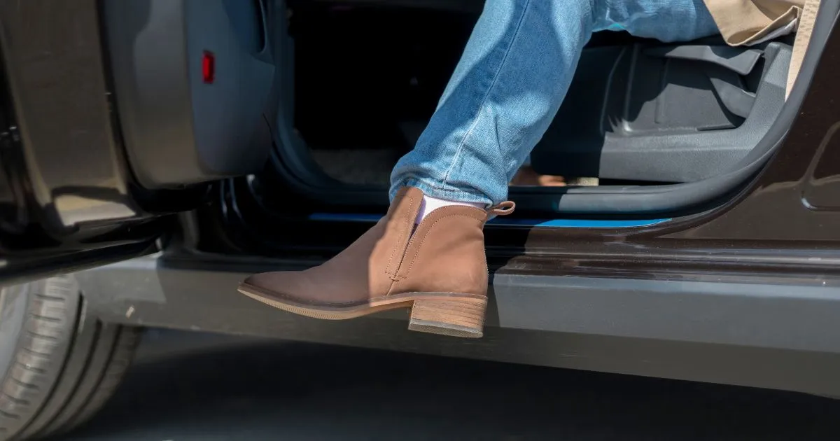 Stepping Out in Style A Close-Up of Boots And Denim Exiting A Car Stepping Out in Style A Close-Up of Boots And Denim Exiting A Car