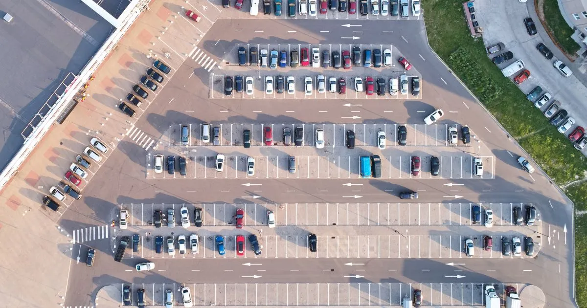 The Aerial View Of A Busy Parking Lot With Many Parked Vehicles