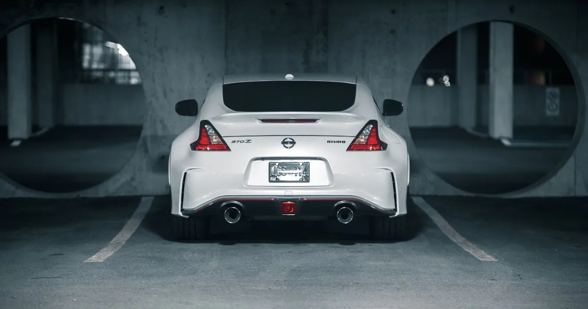 The Rear View Of A White Car Parked In A Garage The Rear View Of A White Car Parked In A Garage