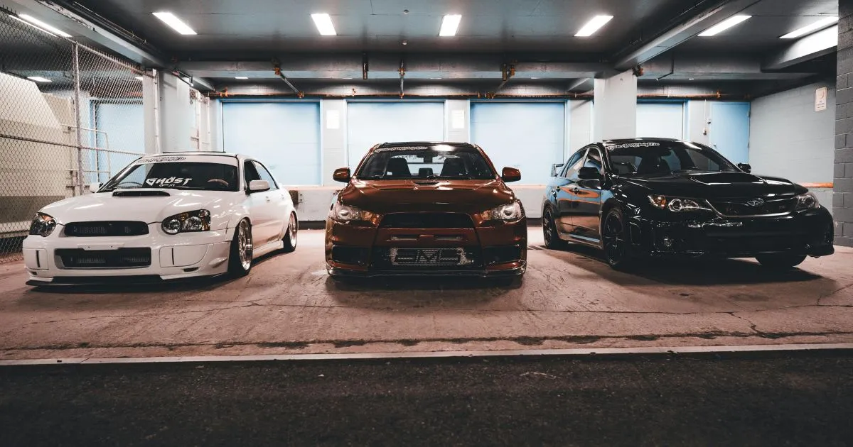 Three Cars Parked In A Long Term Parking Facility Three Cars Parked In A Long Term Parking Facility