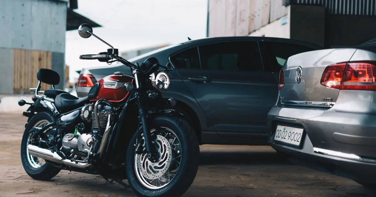 Two Cars And A Motorcycle Parked In A Garage