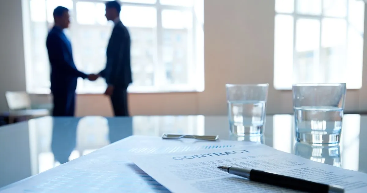 Two Parties Shaking Hands After Finalising A Parking Contract