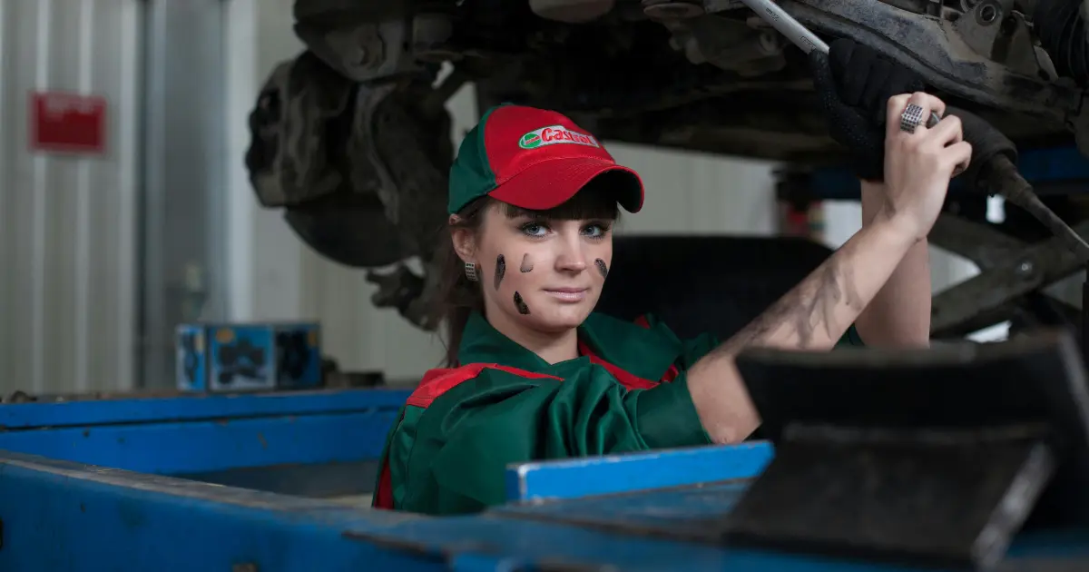 Woman Holding Gray Steel Wrench In Mechanical Workshop Woman Holding Gray Steel Wrench In Mechanical Workshop
